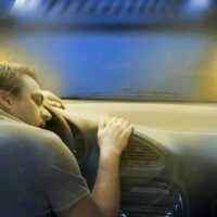 man sleeping on the car